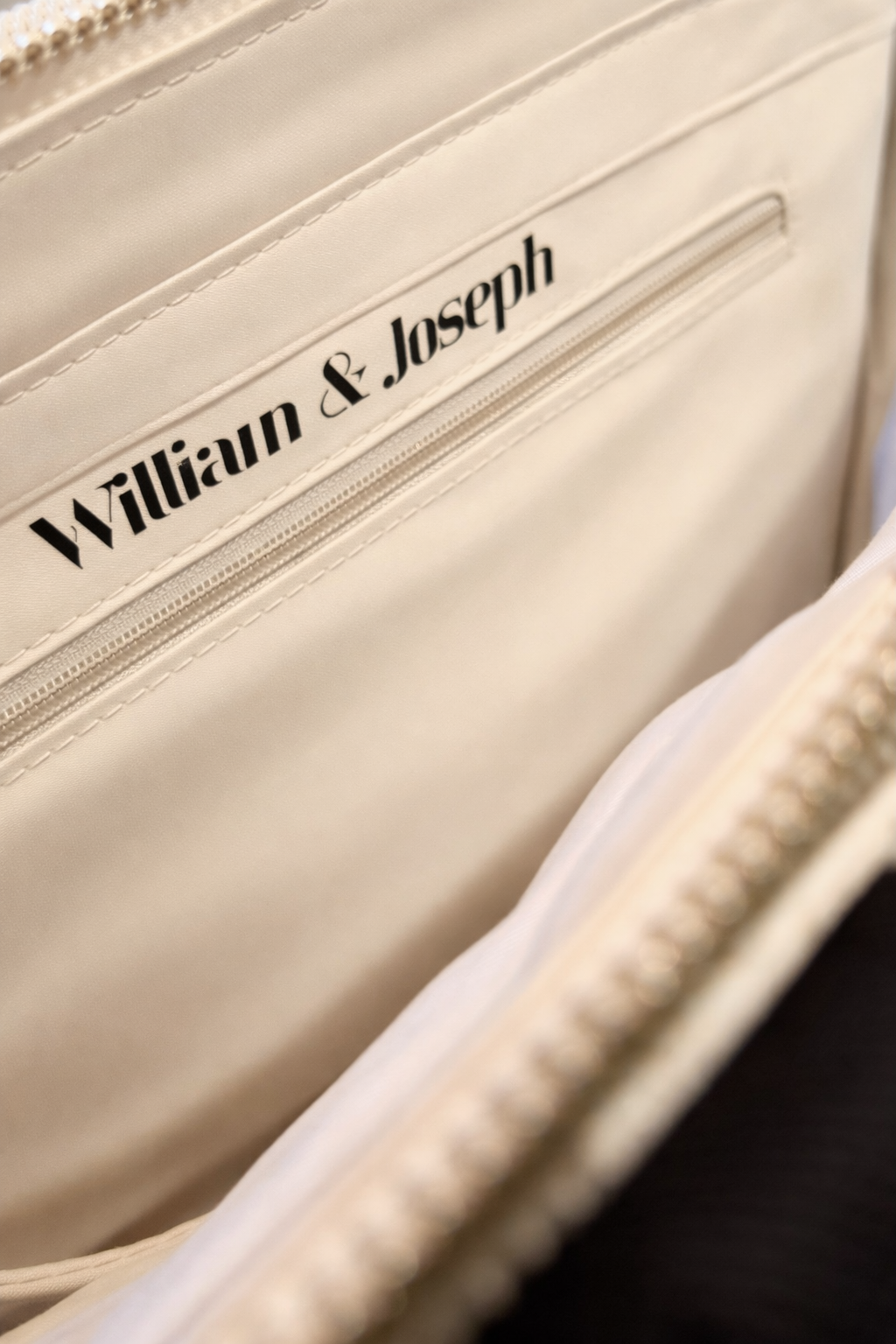 Close-up of a beige bag lining with 'William & Joseph' branding.