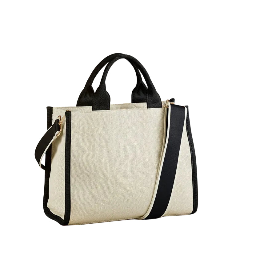 Beige tote bag with black handles and straps on a white background