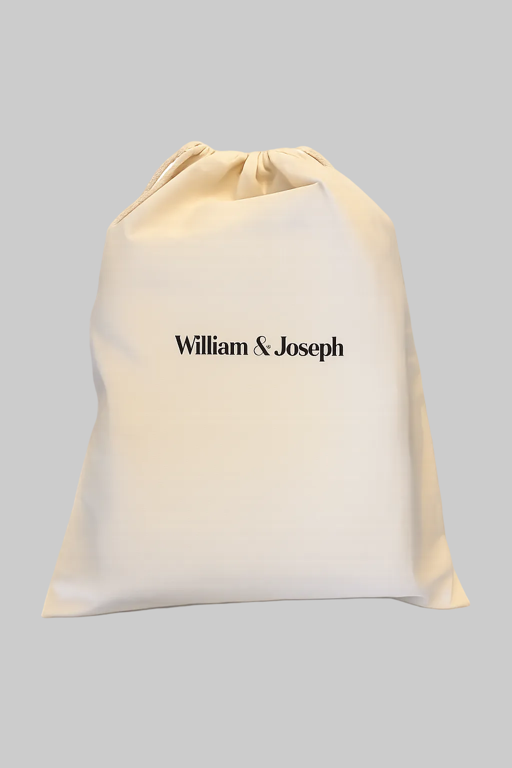 Beige drawstring bag with 'William & Joseph' branding on a white background